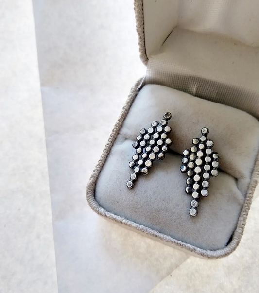blackened silver dotted geometric post earrings in a display box, by Alice Scott
