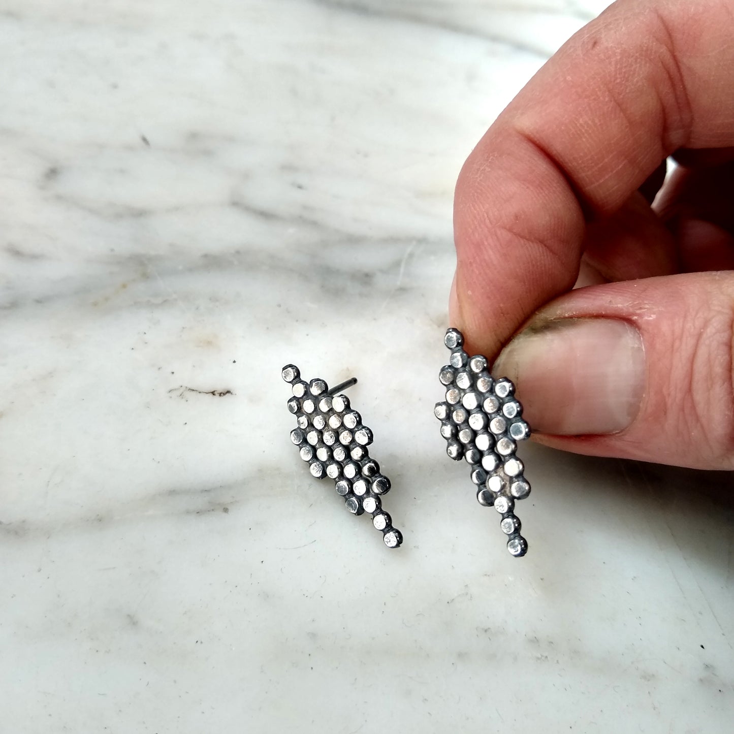 blackened silver dotted geometric post earrings on marble background, by Alice Scott