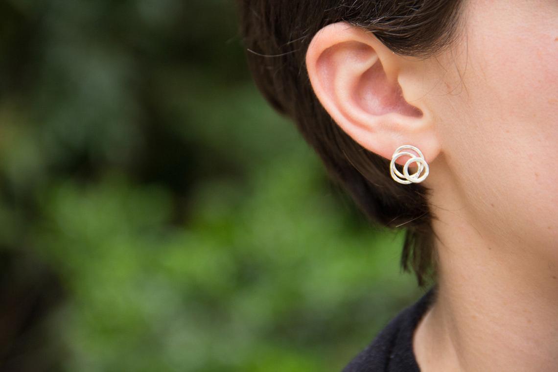 silver circle galaxy posts on model ear by Alice Scott