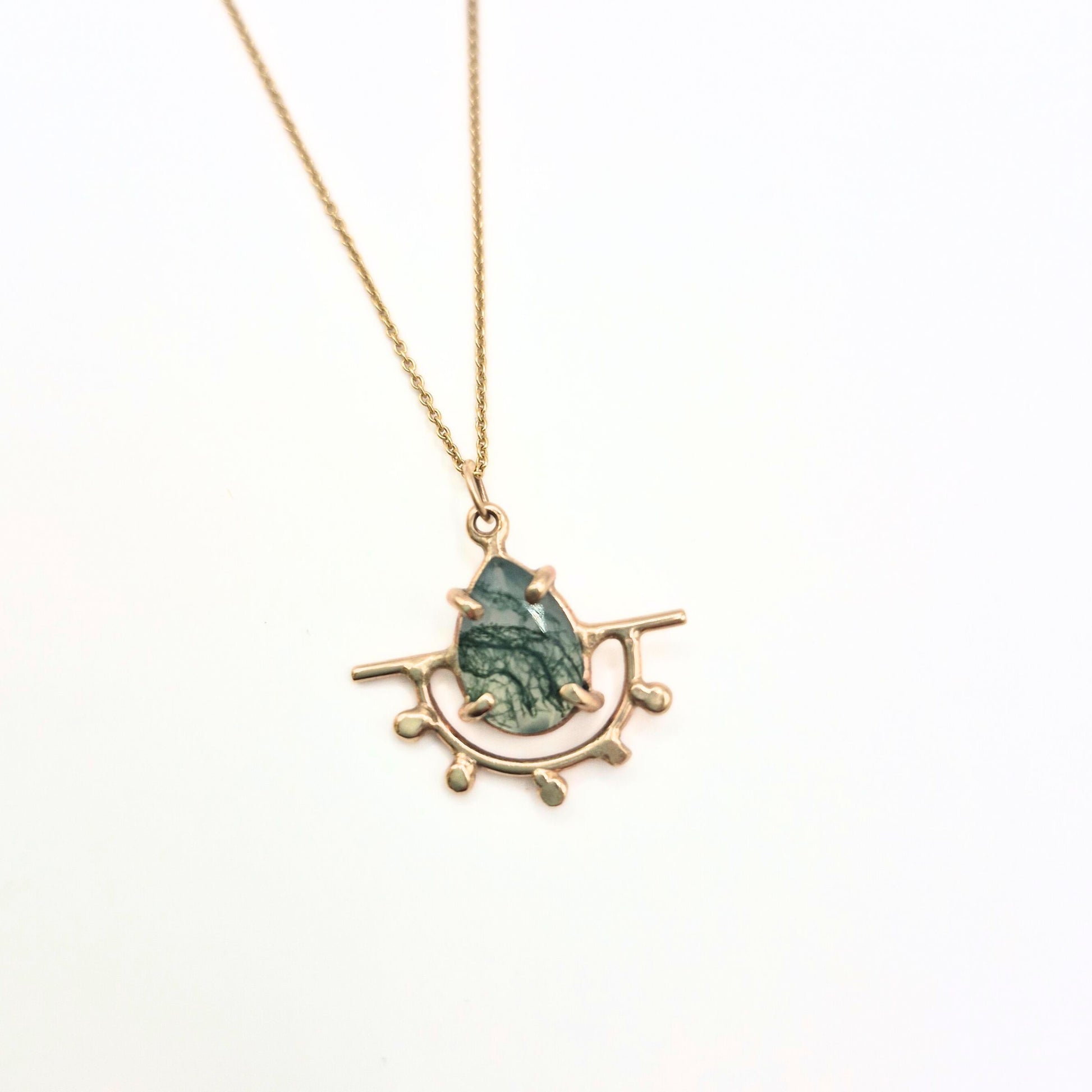gold pendant on white background with moss agate stone by Alice Scott